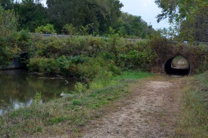 Pipe like tunnel under road on Hennepin Trail feeded canal ride.