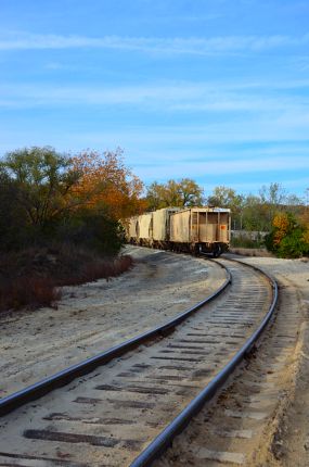 Train tracks and train crossing canal trail